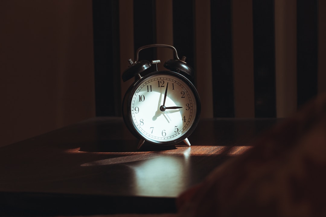 Alarm clock glowing on a nightstand in the middle of the night