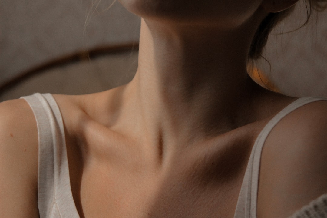 Woman touching her neck in discomfort