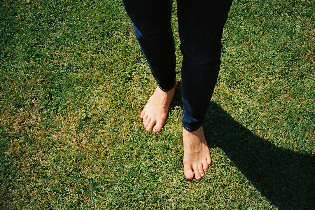 Bare feet standing on grass