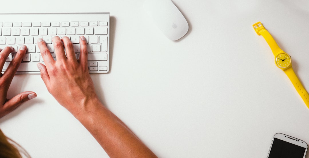 Hands typing at a desk, illustrating wrist strain
