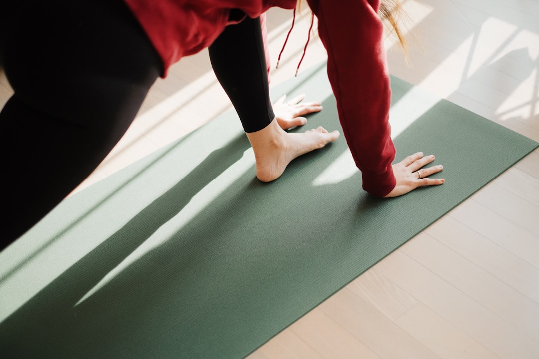 Woman stretching her hip on a yoga mat
