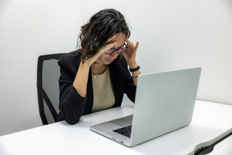 Woman holding her forehead with a headache