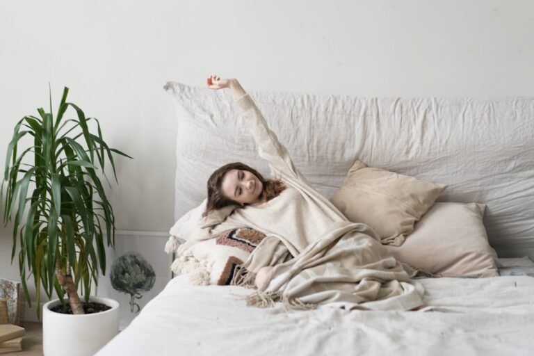 Woman waking up refreshed under a blanket