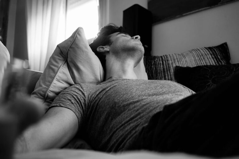 Man stretching after waking up in bed