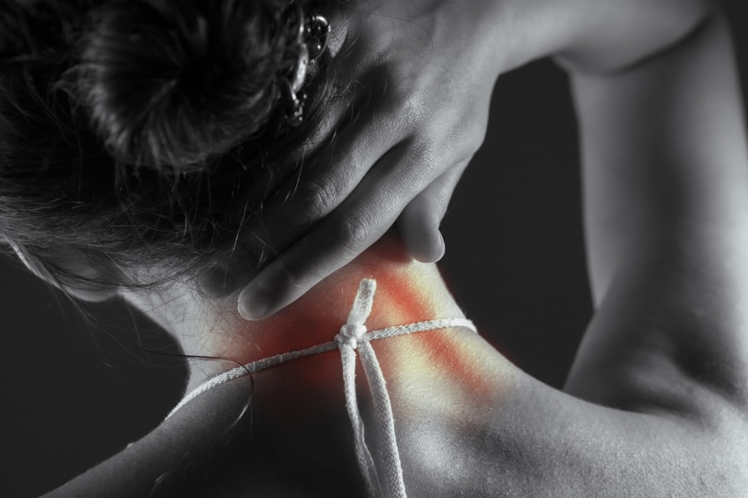 Woman experiencing acute neck and shoulder pain