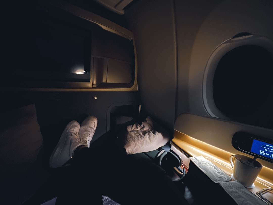 Person sleeping on airplane - YU SLEEP for jet lag